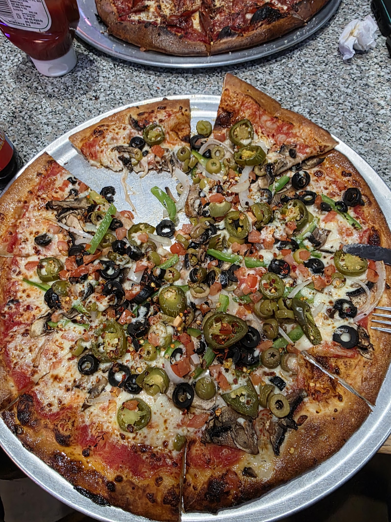 Loaded veggie pizza with olives, jalapeños, and peppers