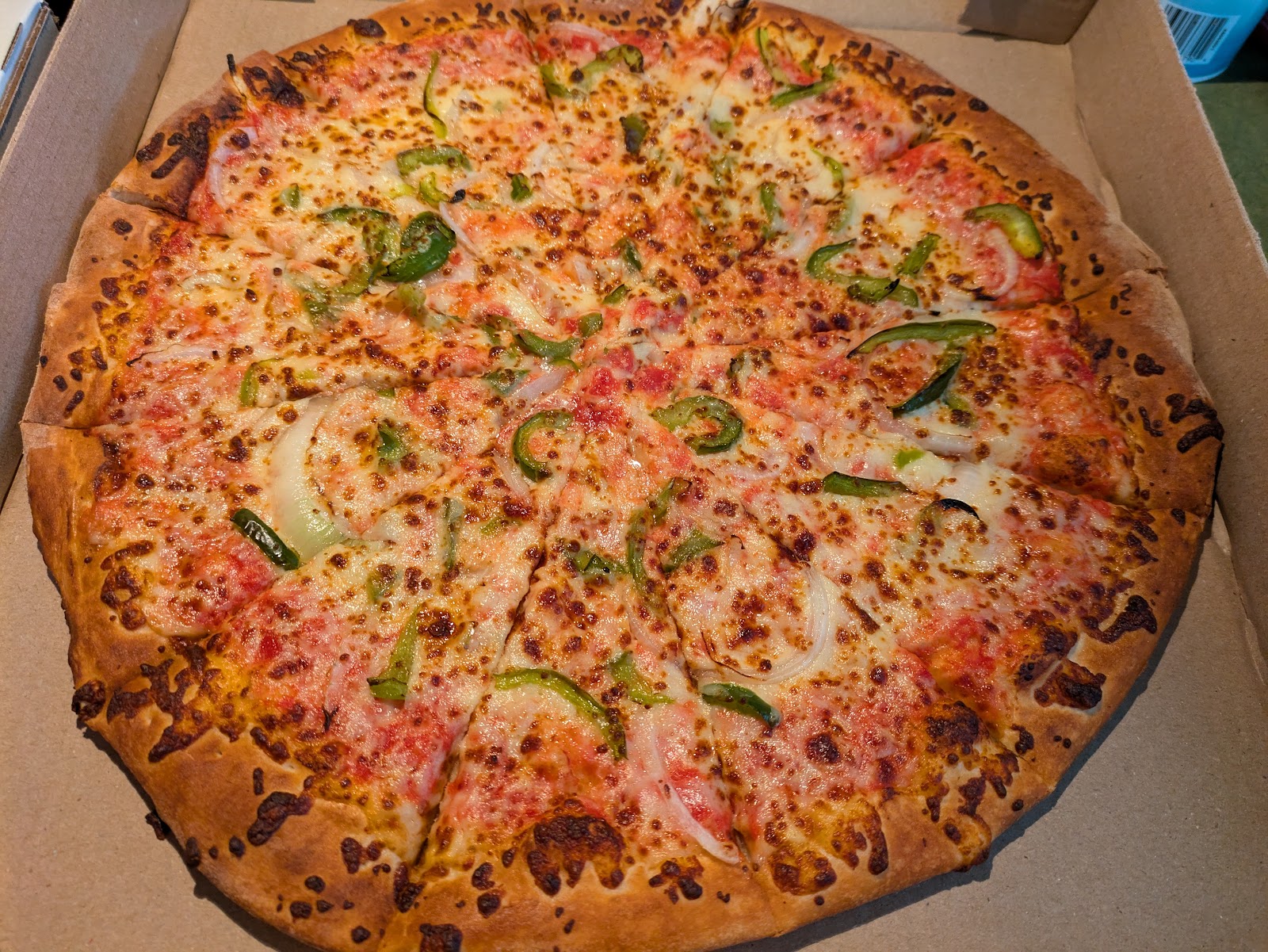 Pizza topped with green peppers and onions