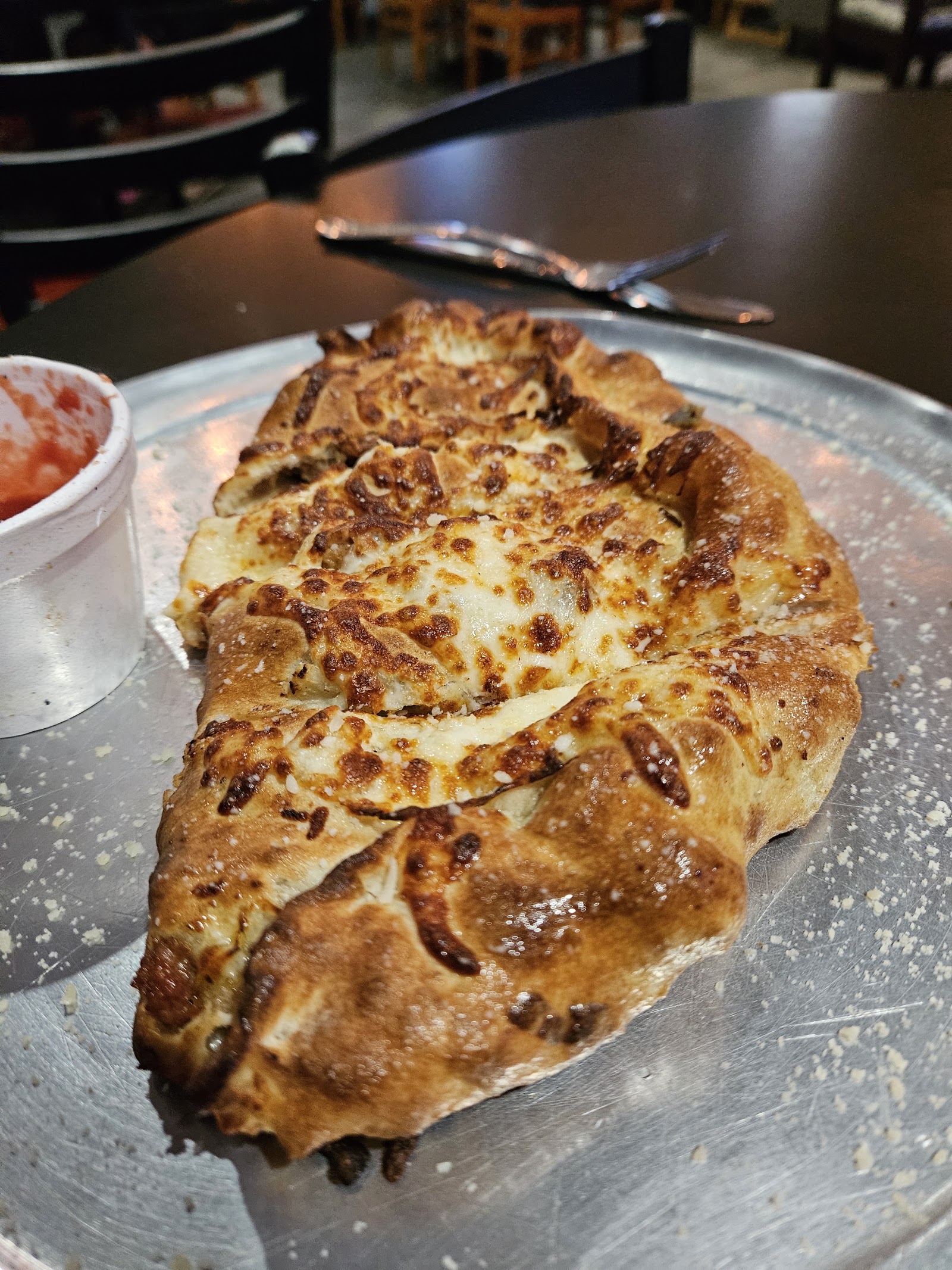 Golden-baked cheese calzone with marinara sauce